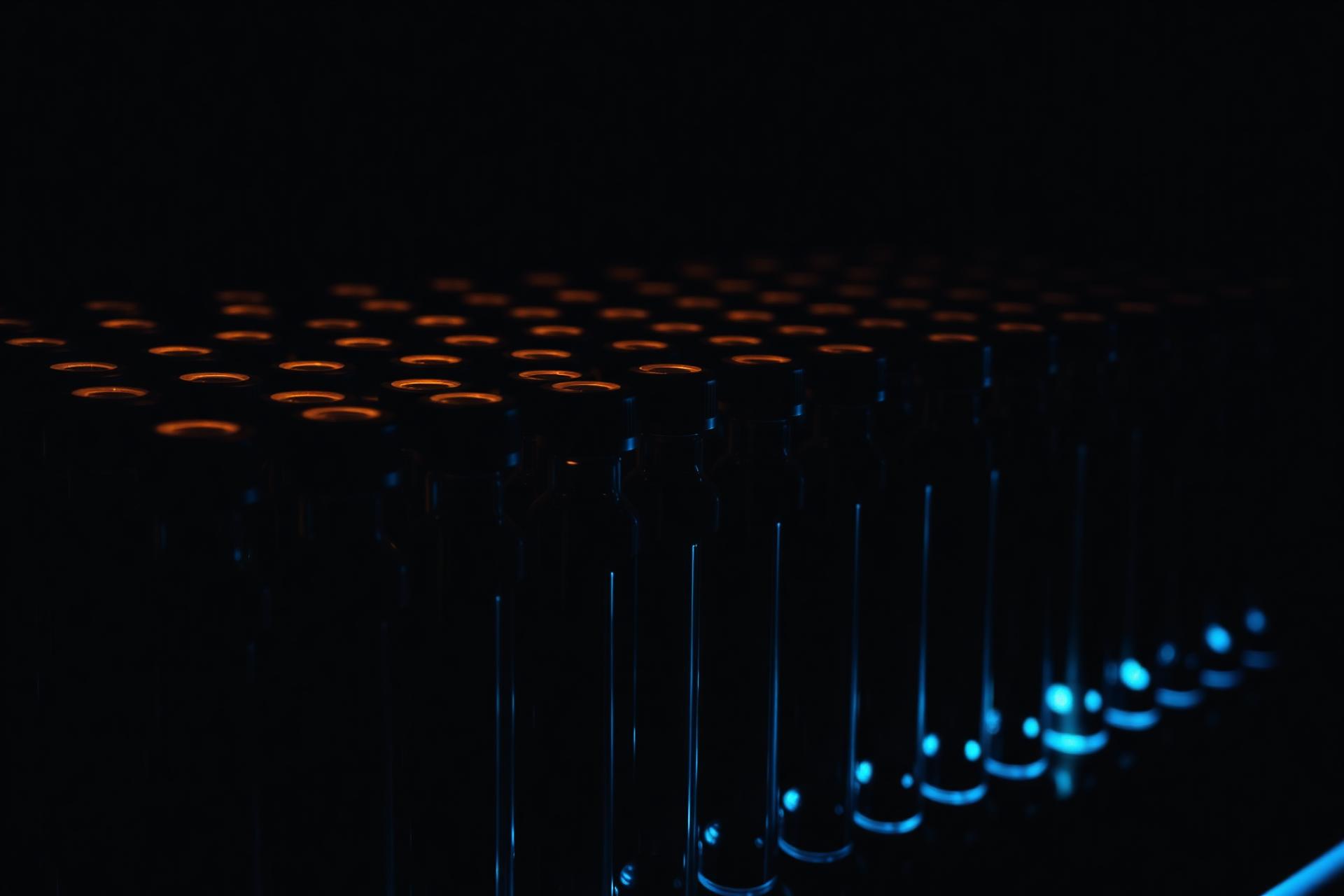 Rows of research vials in a dark laboratory